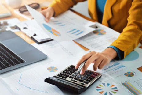 Woman,Accountant,Use,Calculator,And,Computer,With,Holding,Pen,On